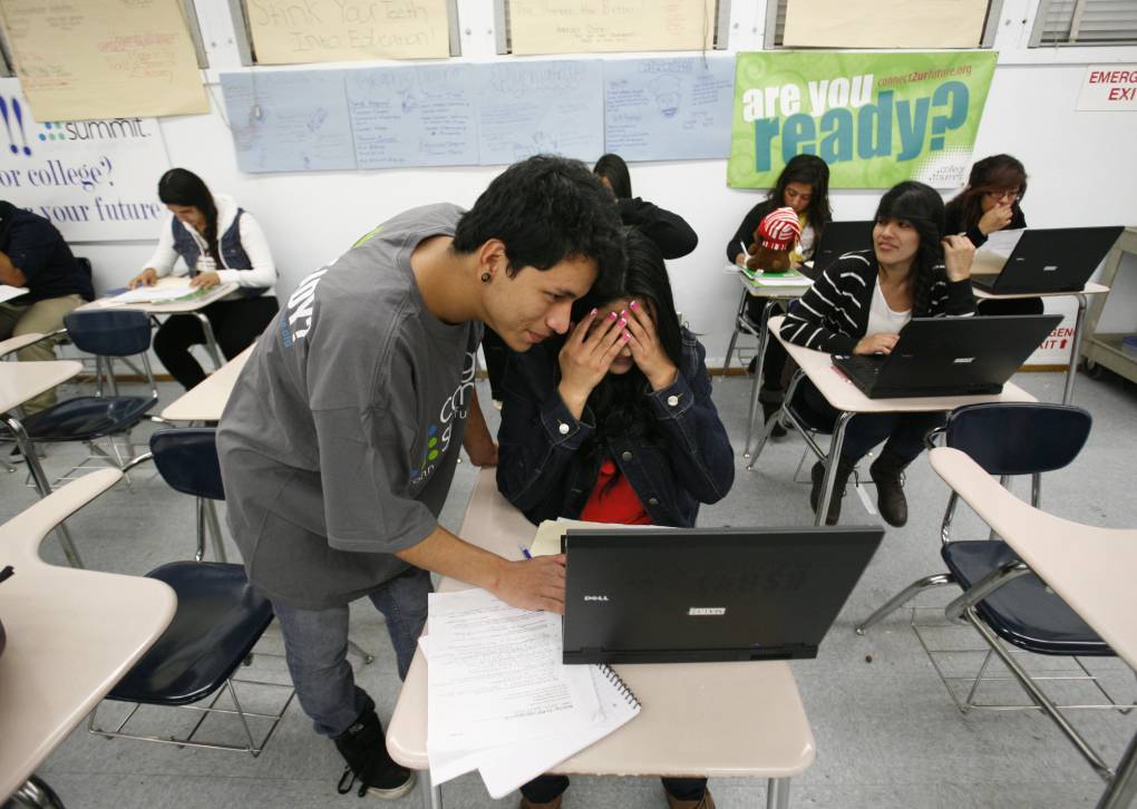 People look at a computer and appear frustrated.